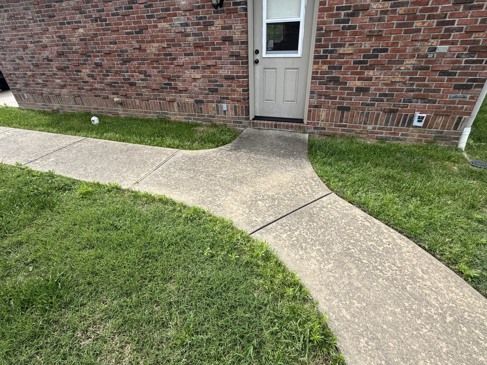 Brick house walkway before pressure washing
